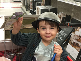 Marcy's son with a collander on his head.